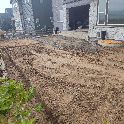 Bare dirt backyard before patio and lawn installation