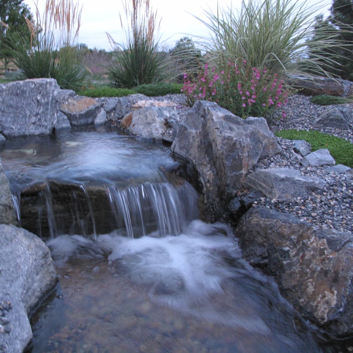 Custom water feature and planting bed in Edwards