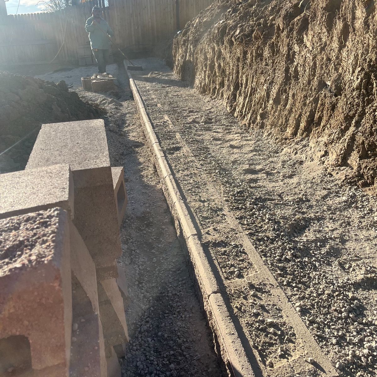 Engineered base course being leveled for new retaining wall in Arvada CO