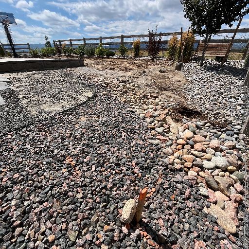 Littleton, Colorado backyard before the retaining wall, paver, and sod installation