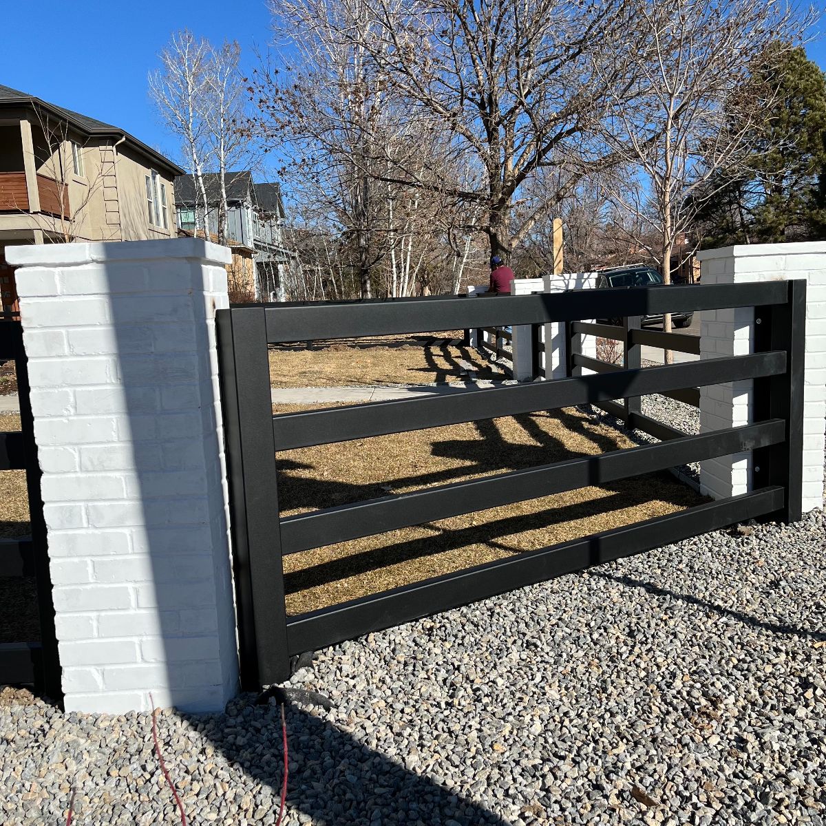 Steel fence with brick columns built in Denver, Colorado