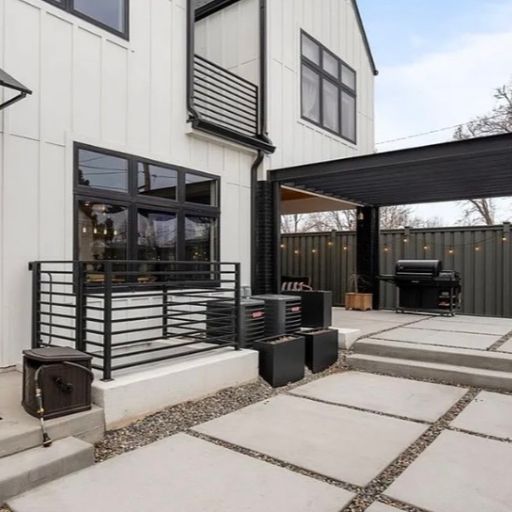 Completed steel pergola and concrete patio installation in a Denver, Colorado backyard